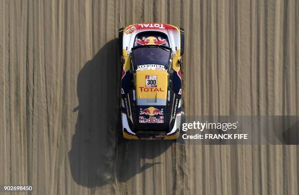 Peugeot's driver Stephane Peterhansel and his co-driver Jean Paul Cottret of France compete during Stage 3 of the Dakar 2018 between Pisco and San...