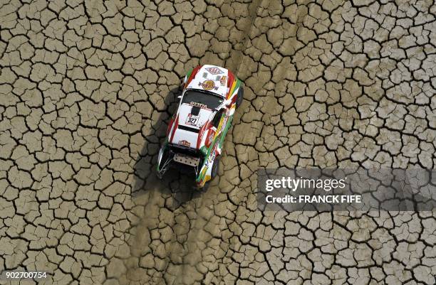 Bolivia's driver Marco Bulacia and his co-driver Eugenio Arrieta steer their Ford during Stage 3 of the Dakar 2018 between Pisco and San Juan de...