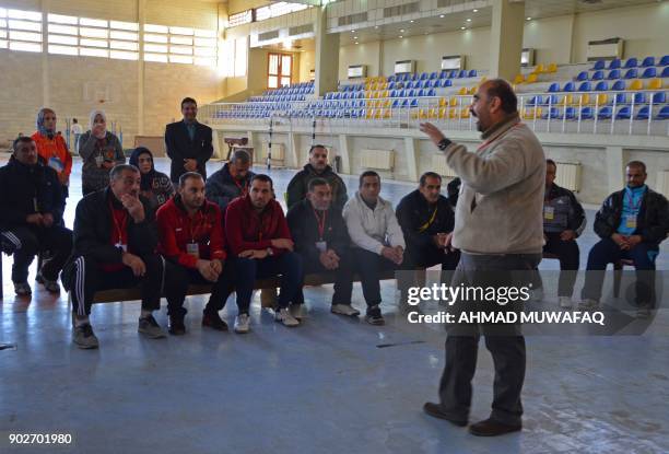 Ahmad Waadallah, a professor of psychology, leads a training to school teachers on how best to handle students suffering from trauma at a university...