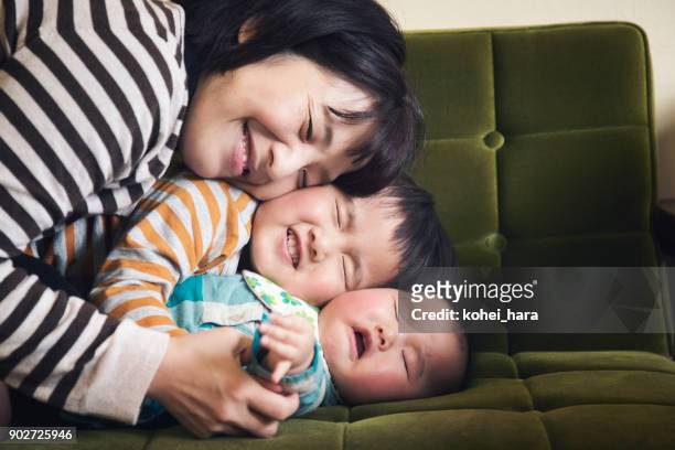 family relaxed at home - sibling hugging stock pictures, royalty-free photos & images