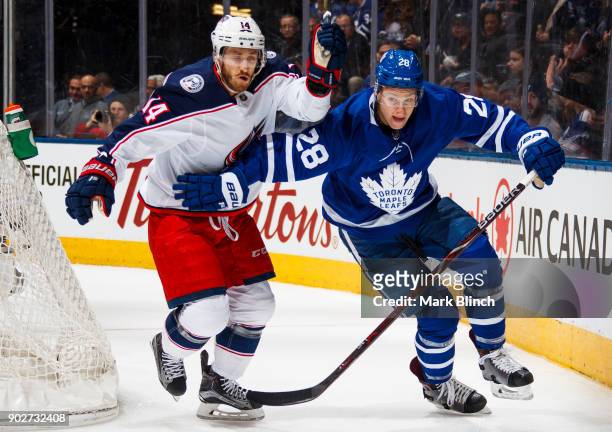 Connor Brown of the Toronto Maple Leafs skates against Jordan Schroeder of the Columbus Blue Jackets during the first period at the Air Canada Centre...