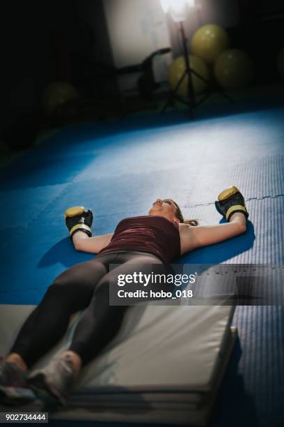 exhausted from intense training - woman collapsing stock pictures, royalty-free photos & images