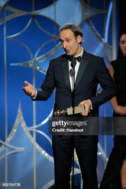 In this handout photo provided by NBCUniversal, Alexandre Desplat accepts the award for Best Original Score – Motion Picture for “The Shape of Water”...