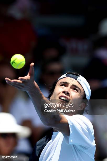 Taro Daniel of Japan serves in his first round match against Pablo Cuevas or Uruguay during day two of the ASB Men's Classic at ASB Tennis Centre on...