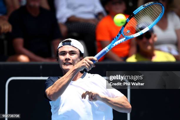 Taro Daniel of Japan plays a forehand in his first round match against Pablo Cuevas or Uruguay during day two of the ASB Men's Classic at ASB Tennis...