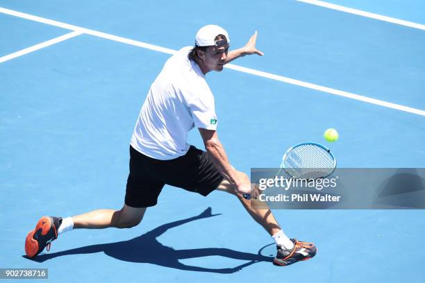 Taro Daniel of Japan plays a backhand in his first round match against Pablo Cuevas or Uruguay during day two of the ASB Men's Classic at ASB Tennis...