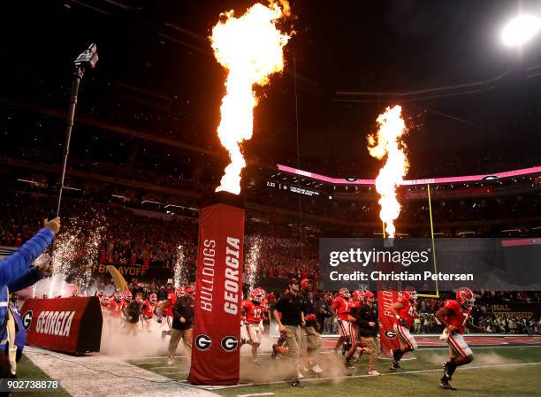 The Georgia Bulldogs run out on the field prior to the game against the Alabama Crimson Tide in the CFP National Championship presented by AT&T at...