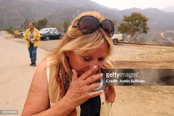 Wildlife Waystation founder Martine Colette wipes a tear after she watched a group of chimpanzees being evacuated from the 160 acre animal sanctuary...