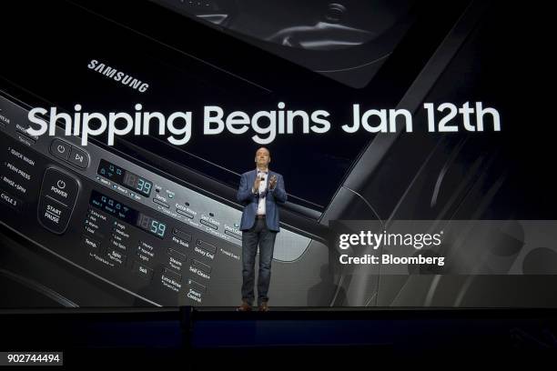 Tim Baxter, president and chief executive officer of Samsung Electronics America Inc., applauds during the company's press conference at the 2018...