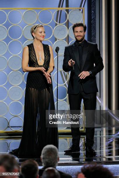 In this handout photo provided by NBCUniversal, Kate Hudson and Aaron Taylor Johnson speak onstage during the 75th Annual Golden Globe Awards at The...