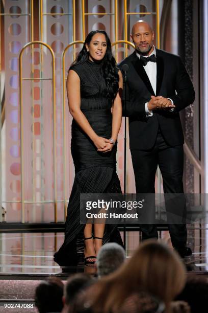 In this handout photo provided by NBCUniversal, Golden Globe Ambassador Simone Garcia Johnson and Dwayne Johnson speak onstage during the 75th Annual...