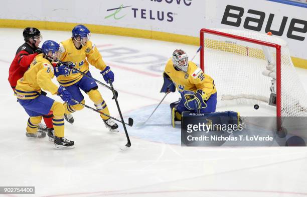 Filip Gustavsson of Sweden watches the shot by Dillon Dubé of Canada enter the net to give Canada a 1-0 lead during the second period of play in the...