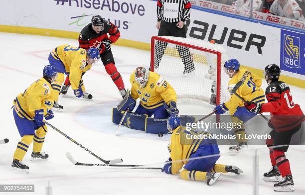 Filip Gustavsson of Sweden makes a pad save against Canada during the second period of play in the IIHF World Junior Championships Gold Medal game at...