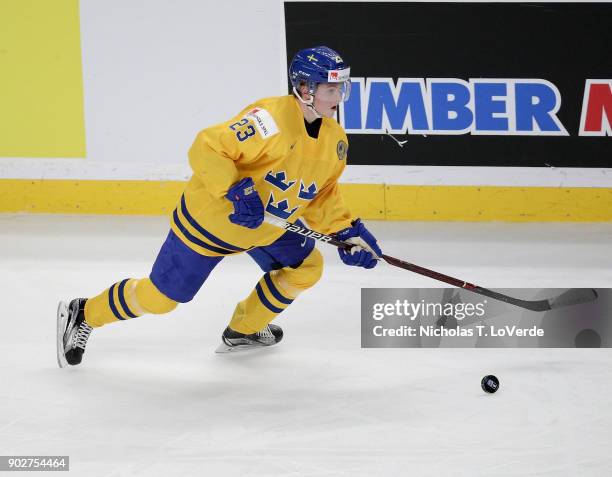 Jesper Sellgren of Sweden skates the puck against team Canada during the third period of play in the IIHF World Junior Championships Gold Medal game...