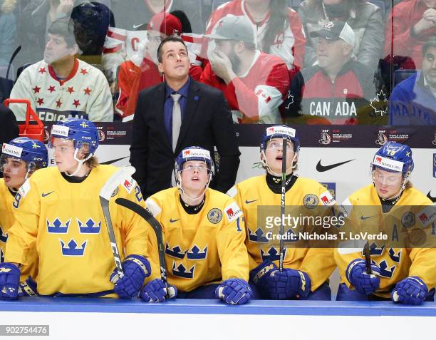 Sweden head coach Tomas Monten looks to the scoreboard at a replay of a penalty against Sweden during the third period of play against Canada in the...