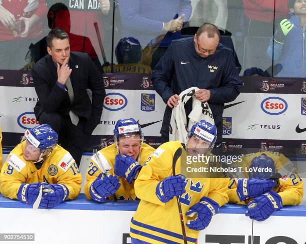 Sweden head coach Tomas Monten, and team Sweden look on as the final seconds tick off the clock with a 3-1 loss to team Canada during the third...