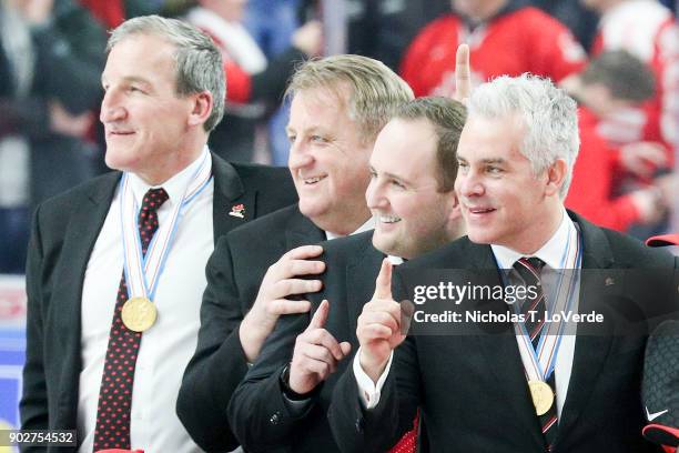 Team Canada coaching staff celebrate Canada's 3-1 win over Sweden with their gold medals following the third period of play in the IIHF World Junior...