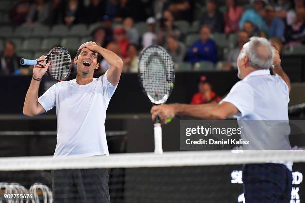 Mark Philippoussis of Australia and Mansour Bahrami of Iran react after defeating Henri Leconte of France and Mats Wilander of Sweden during day one...