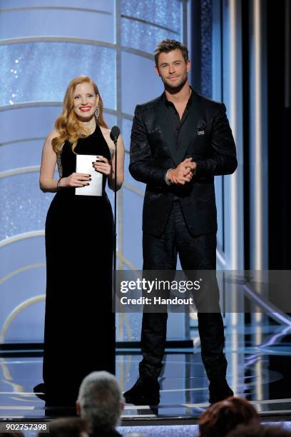 In this handout photo provided by NBCUniversal, Presenters Jessica Chastain and Chris Hemsworth speak onstage during the 75th Annual Golden Globe...