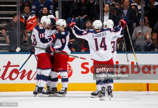 Artemi Panarin of the Columbus Blue Jackets celebrates his game winning overtime goal against the Toronto Maple Leafs with teammates Pierre-Luc...