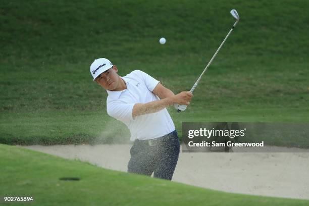 Xinjun Zhang of China plays a shot during practice rounds prior to the Sony Open In Hawaii at Waialae Country Club on January 8, 2018 in Honolulu,...