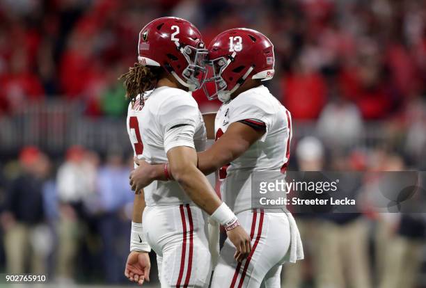 Tua Tagovailoa celebrates a touchdown pass with Jalen Hurts of the Alabama Crimson Tide during the third quarter against the Georgia Bulldogs in the...