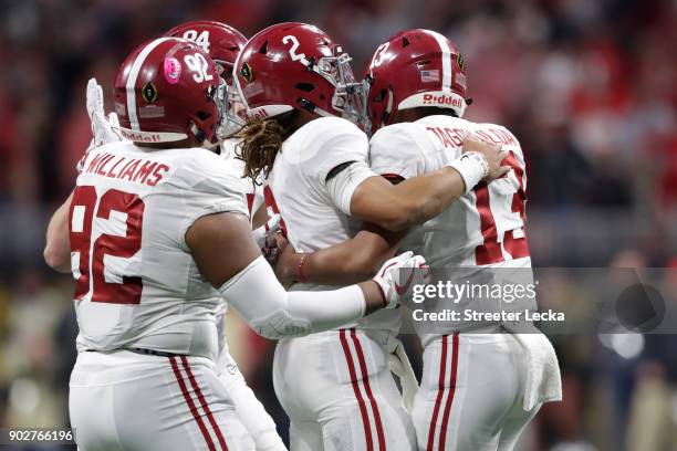 Tua Tagovailoa celebrates a touchdown pass with Jalen Hurts of the Alabama Crimson Tide during the third quarter against the Georgia Bulldogs in the...