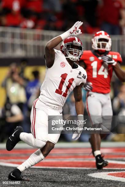 Henry Ruggs III of the Alabama Crimson Tide celebrates a six yard touchdown catch during the third quarter against the Georgia Bulldogs in the CFP...