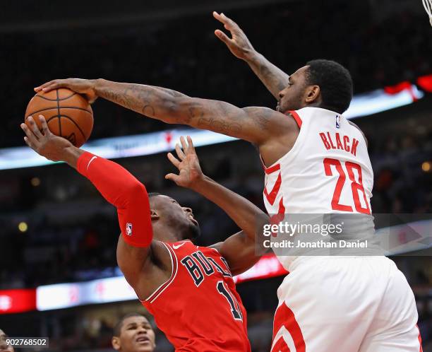 Tarik Black of the Houston Rockets blocks a shot by David Nwaba of the Chicago Bulls at the United Center on January 8, 2018 in Chicago, Illinois....