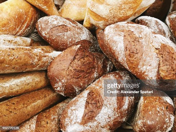 fresh baked bread on a display in bakery - bread stock pictures, royalty-free photos & images