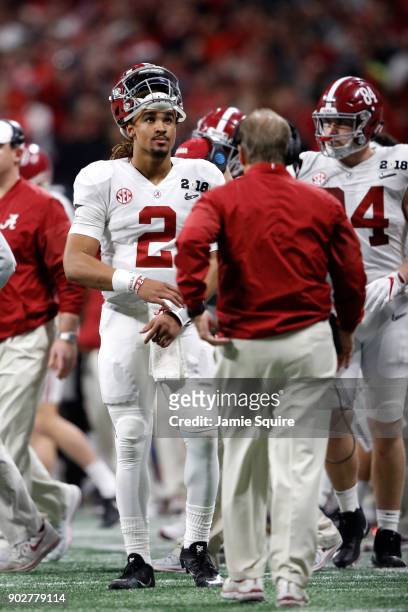 Jalen Hurts of the Alabama Crimson Tide looks on from the sidelines during the second half against the Georgia Bulldogs in the CFP National...
