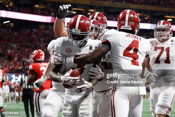 Calvin Ridley of the Alabama Crimson Tide celebrates a seven yard touchdown catch during the fourth quarter against the Georgia Bulldogs in the CFP...