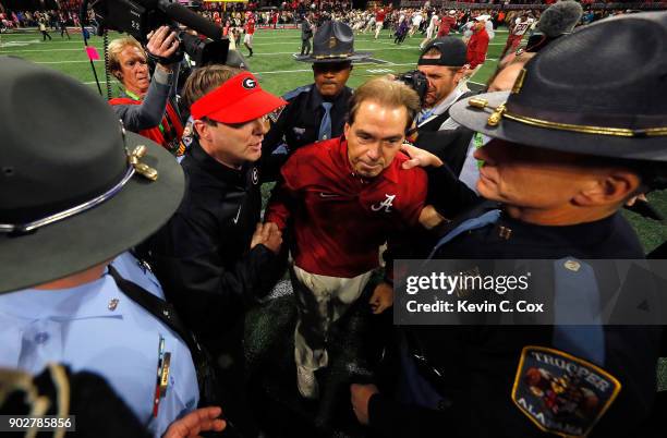 Head coach Nick Saban of the Alabama Crimson Tide shakes hands with head coach Kirby Smart of the Georgia Bulldogs after winning the CFP National...