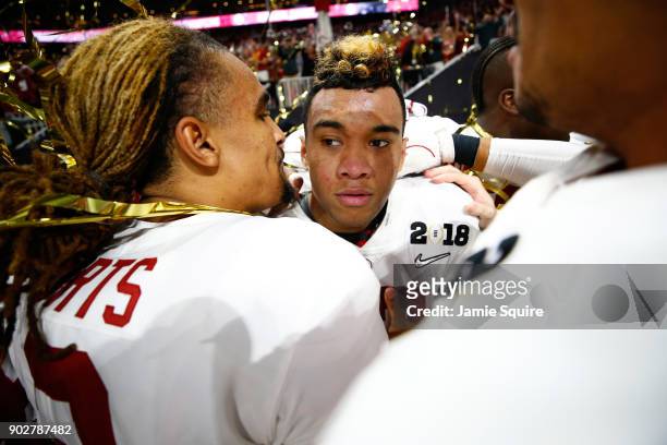 Tua Tagovailoa of the Alabama Crimson Tide celebrates with Jalen Hurts after beating the Georgia Bulldogs in overtime to win the CFP National...