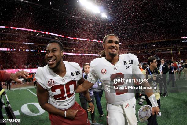 Jalen Hurts and Shaun Dion Hamilton of the Alabama Crimson Tide celebrate beating the Georgia Bulldogs in overtime to win the CFP National...