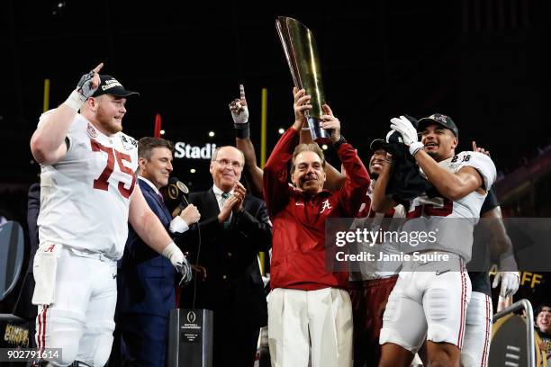 Head coach Nick Saban of the Alabama Crimson Tide holds the trophy while celebrating with his team after defeating the Georgia Bulldogs in overtime...