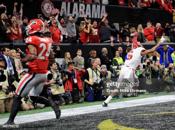 DeVonta Smith of the Alabama Crimson Tide celebrates catching a 41 yard touchdown pass to beat the Georgia Bulldogs in the CFP National Championship...