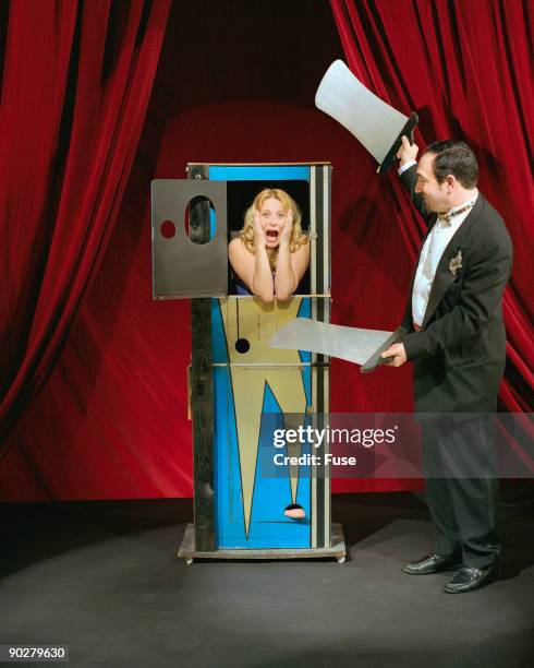 magician  with frightened assistant in box - fuse box stockfoto's en -beelden