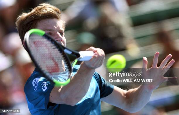 David Goffin of Belgium hits a return to Pablo Carreno Busta of Spain during their men's singles match at Kooyong Classic tennis tournament in...