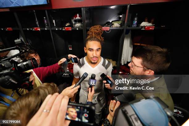 Jalen Hurts of the Alabama Crimson Tide is interviewed in the locker room after beating the Georgia Bulldogs in overtime to win the CFP National...