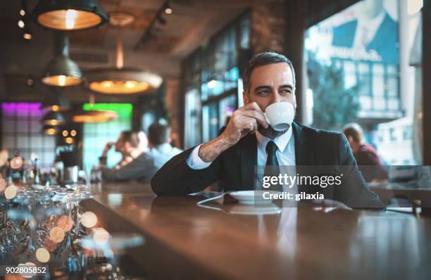 man having a morning coffee in a bar - coffee moustache stock pictures, royalty-free photos & images