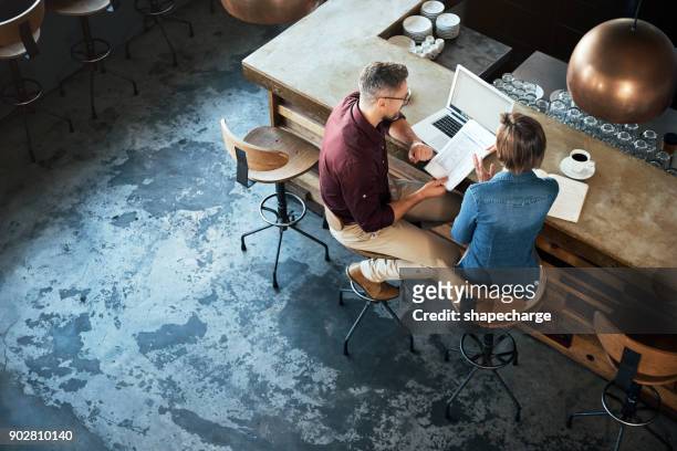 getting work done at their local coffee shop - small business stock pictures, royalty-free photos & images