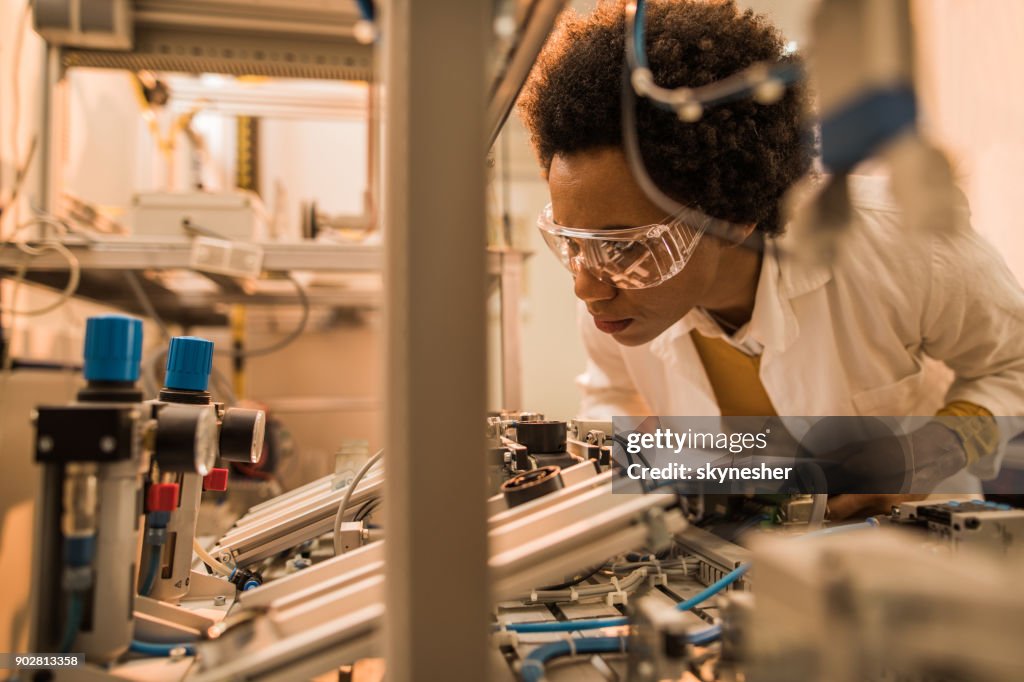 African American Quality Control Inspector Examining Machine Part On ...