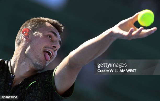 Bernard Tomic of Australia serves against Yoshihito Nishioka of Japan during the men's singles match of the Kooyong Classic tennis tournament in...