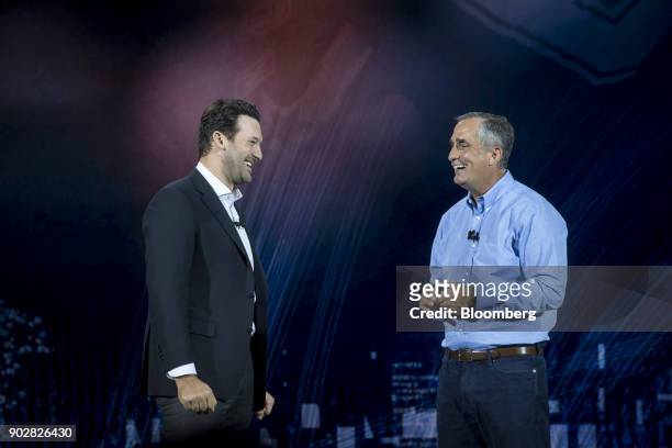 Former National Football League player Tony Romo, left, speaks as Brian Krzanich, chief executive officer of Intel Corp., right, listens during a...