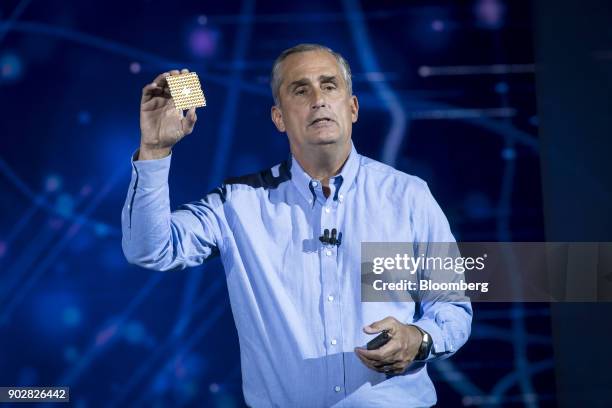 Brian Krzanich, chief executive officer of Intel Corp., holds up a 49-qubit superconducting quantum test chip named 'Tangle Lake' while speaking...