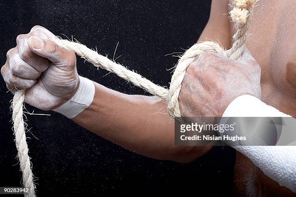 powder sport - male athlete with rope on black background stock pictures, royalty-free photos & images