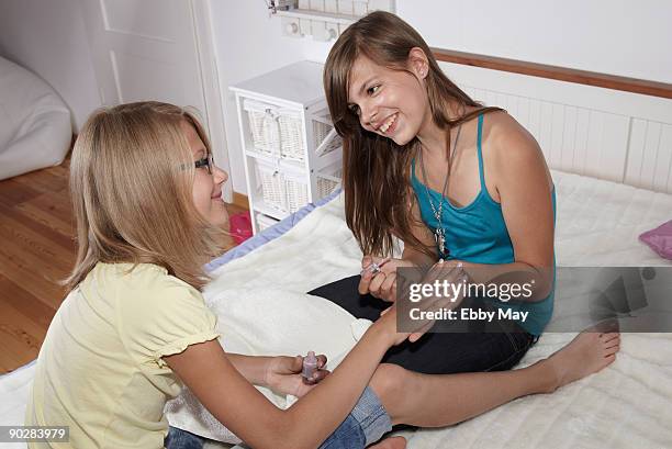 girl varnishing nails of other girl - bad mergentheim stock pictures, royalty-free photos & images