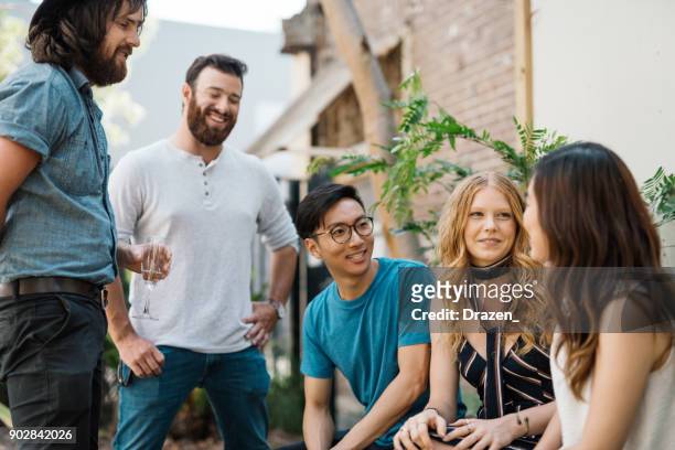 multi ethnic group of beautiful people in australian garden - hipster australia stock pictures, royalty-free photos & images