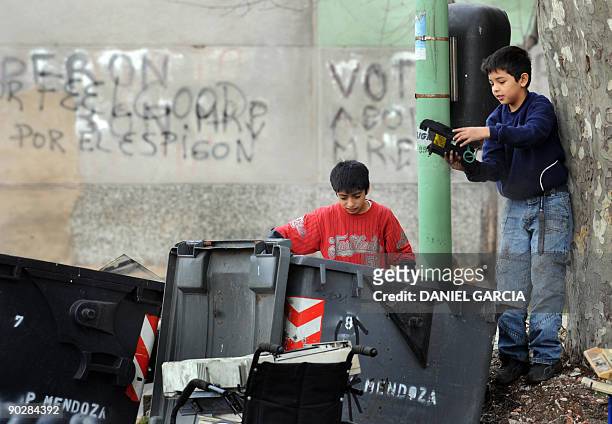 Children play with objects found in garbage cans near the Riachuelo river in Buenos Aires' La Boca neighbourhood, on August 18, 2009. La Boca is...